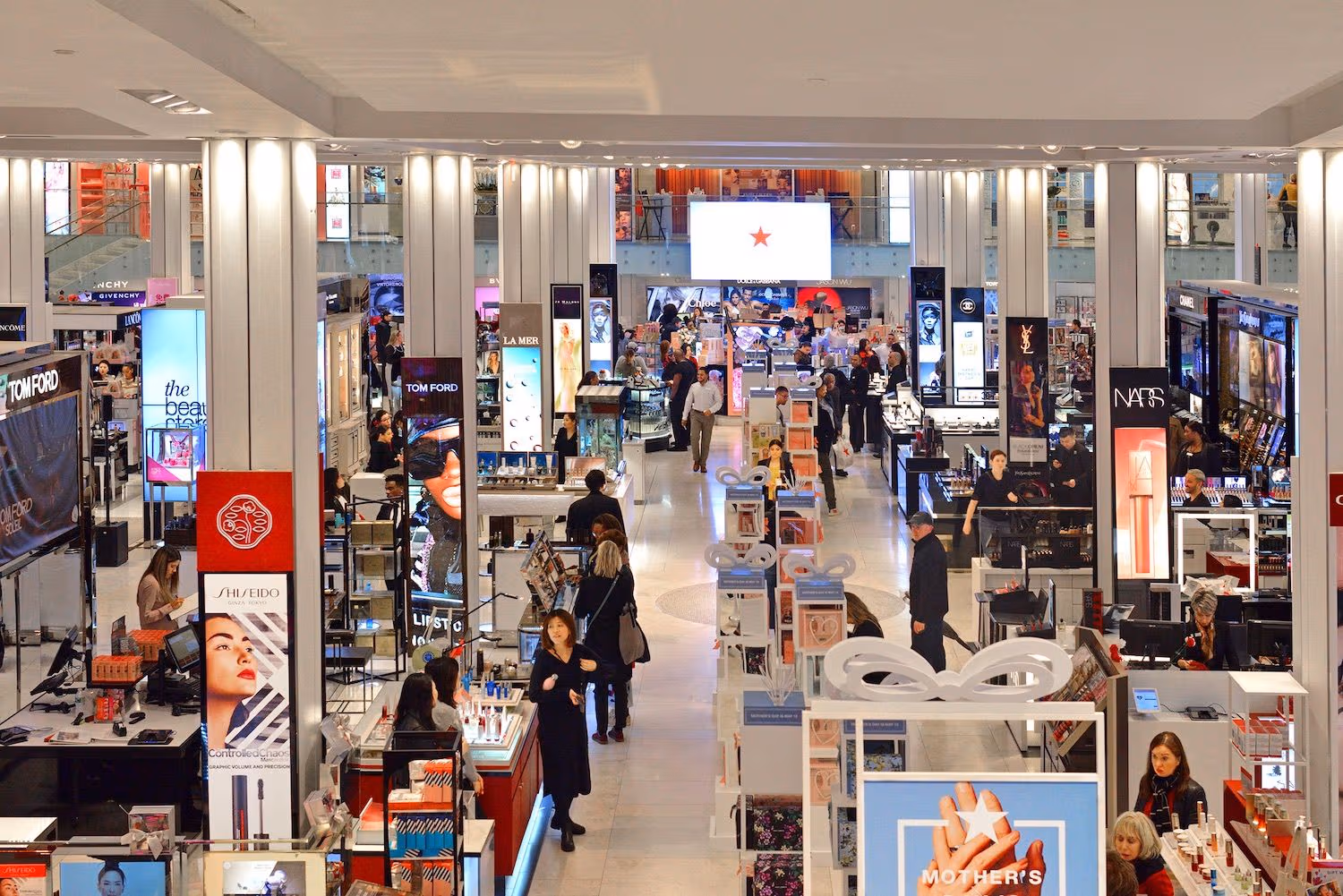 A photograph of a shopper looking down at a retail department store.